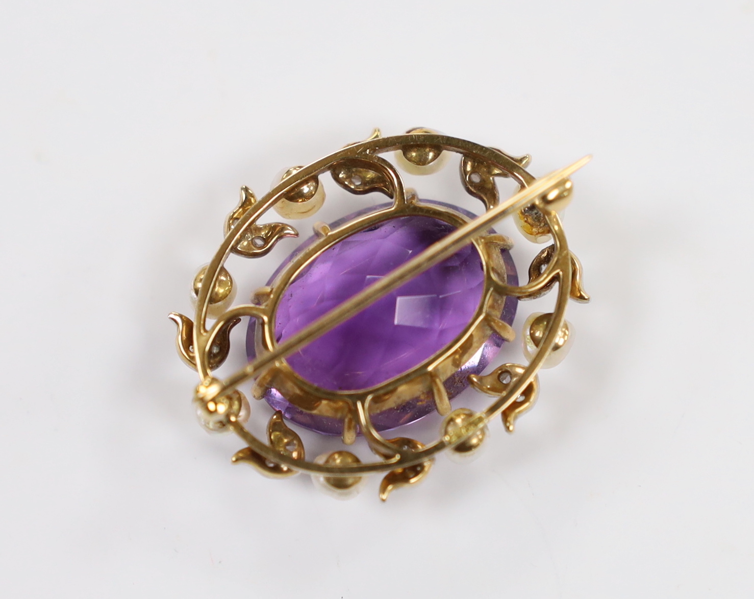 A yellow metal, amethyst, baroque pearl and diamond chip set oval brooch, 32mm, gross weight 11.4 grams.